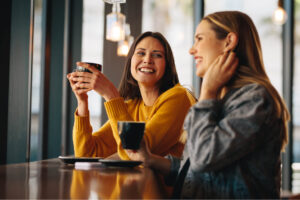 Two young women in cafe having coffee
